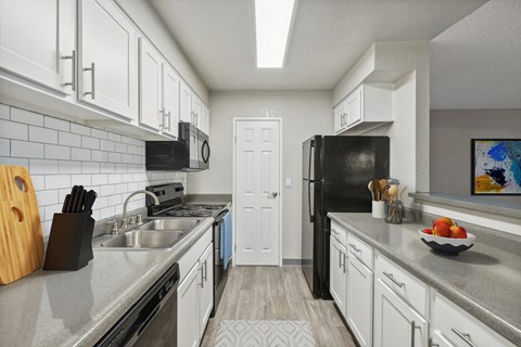 a kitchen with stainless steel appliances and white cabinets