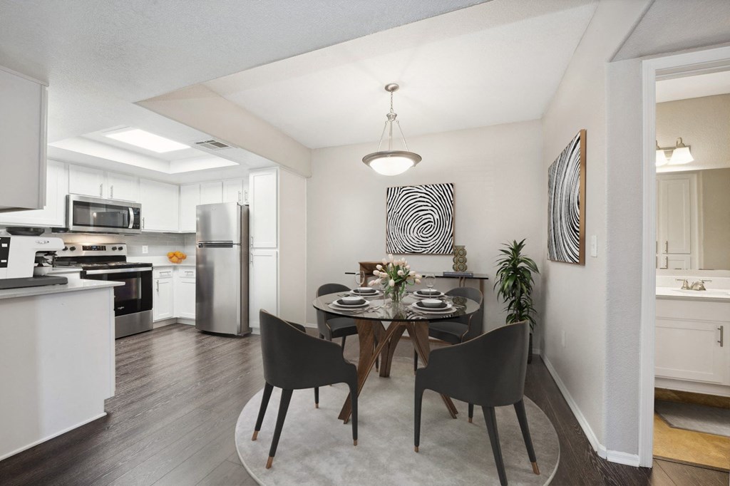 a dining room with a table and black chairs