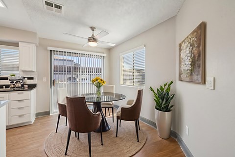 A dining room with a table and chairs.