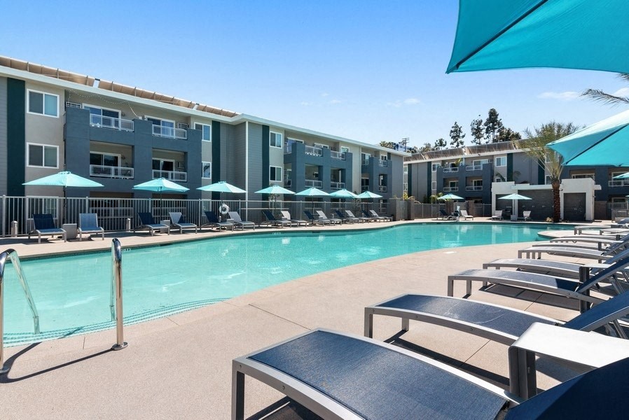 lounge chairs at sparkling pool at Pointe Luxe Apartment Homes, San Diego, CA, 92110