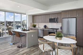 A modern kitchen with a dining table and chairs.