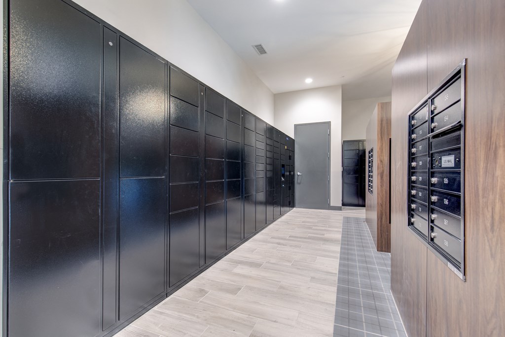 a long hallway with a long row of refrigerators in a large room with wood