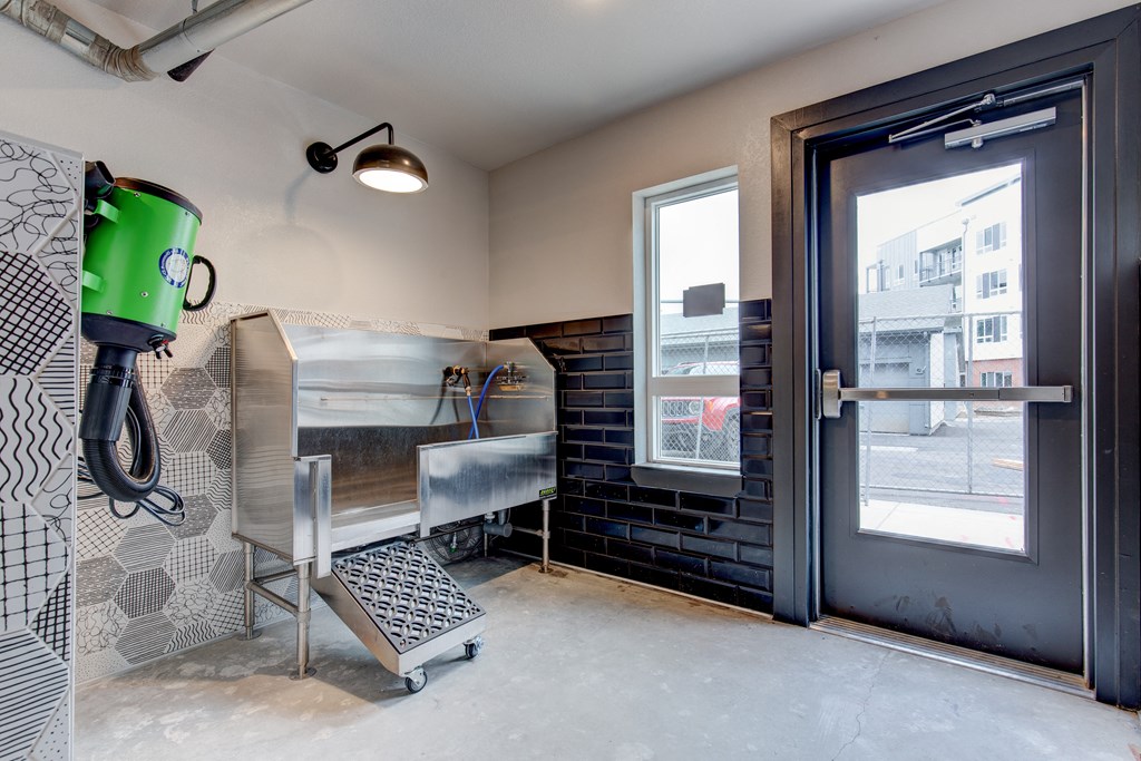 a laundry room with a sink and a door to a street