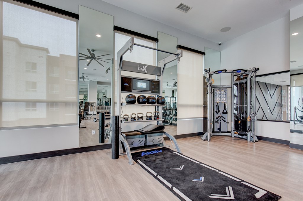 a home gym with exercise equipment and glass doors