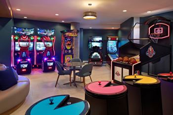 A room with a pool table and a basketball hoop.