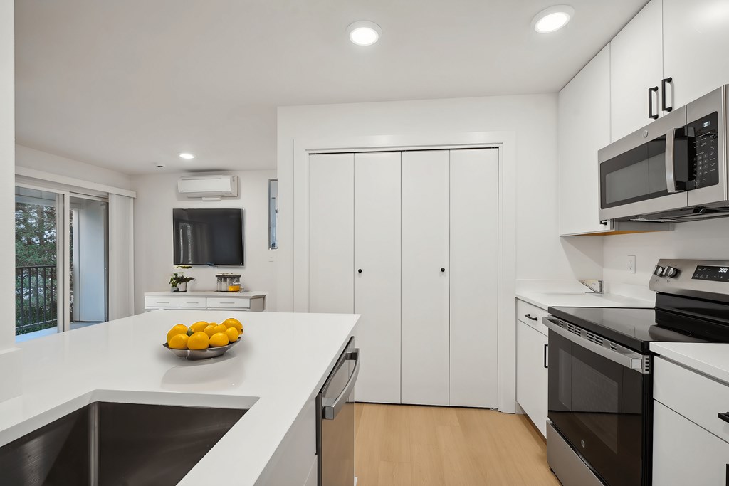 A kitchen with a bowl of lemons on the counter.