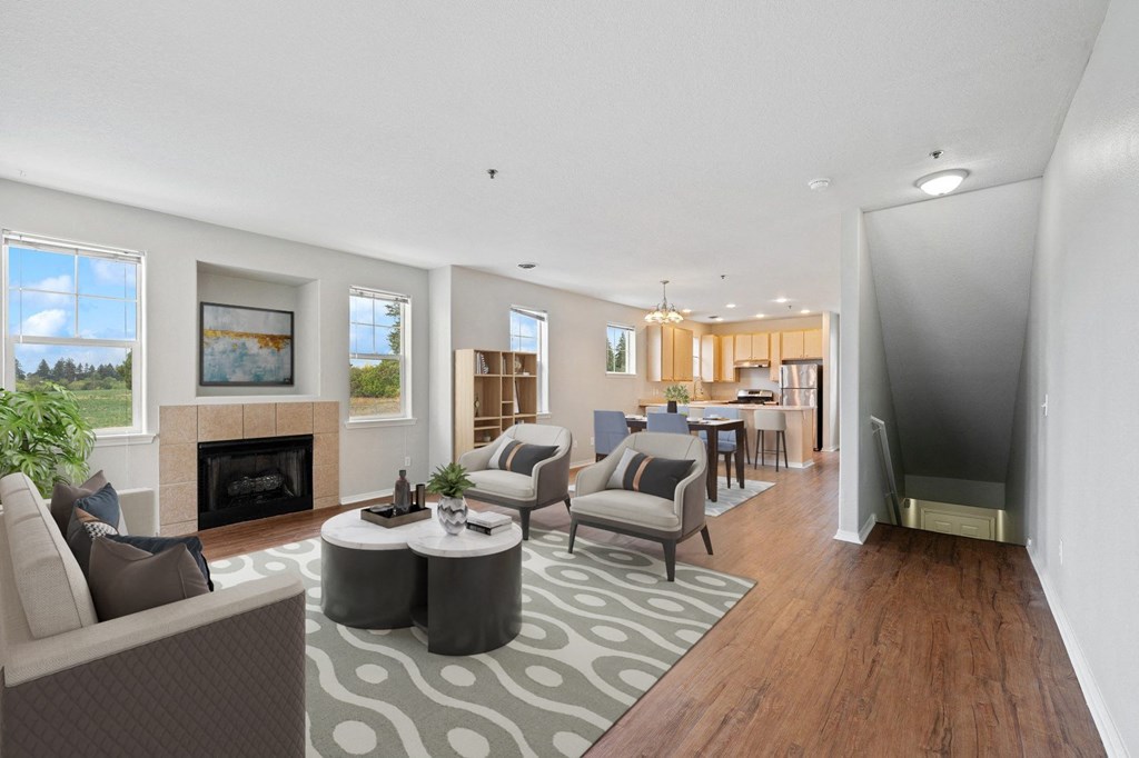 a living room with couches and chairs and a fireplace