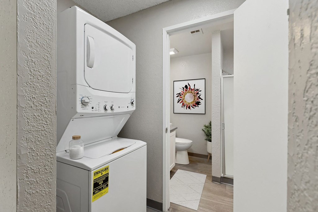 an empty laundry room with a washer and dryer in it