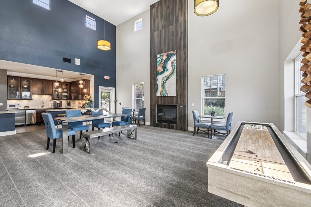 A room with a pool table and a bar area.
