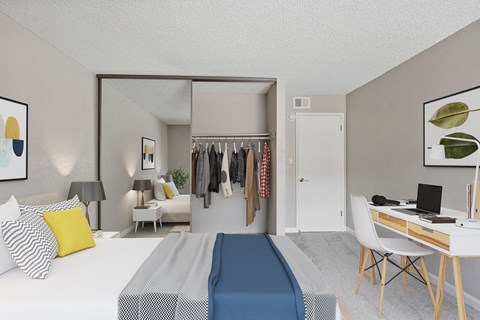a bedroom with a bed and a desk and a closet