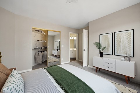 a bedroom with a bed and a dresser and a closet