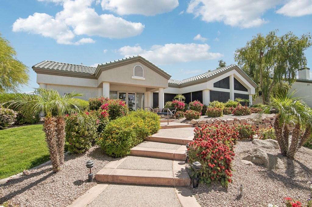 A house with a garden in front of it.