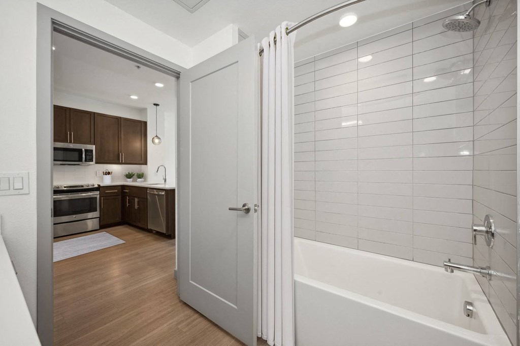 a bathroom with a shower and a sink in a room