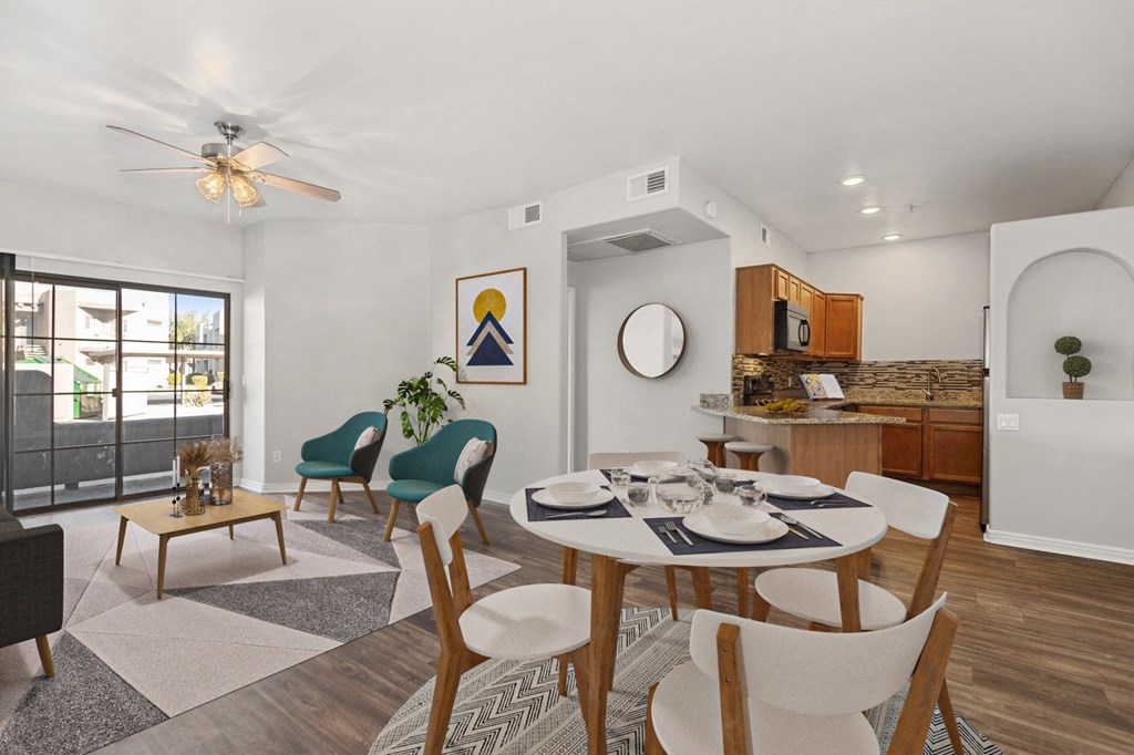 a living room with a dining room table and a kitchen