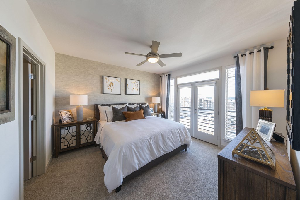 a bedroom with a large bed and a ceiling fan