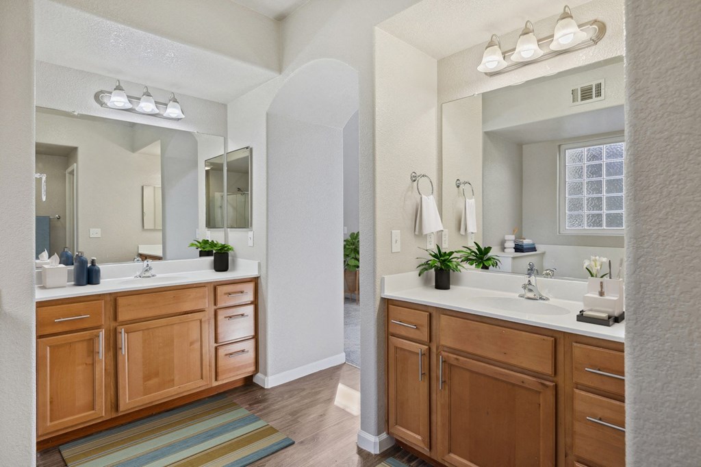 a large bathroom with two sinks and a mirror