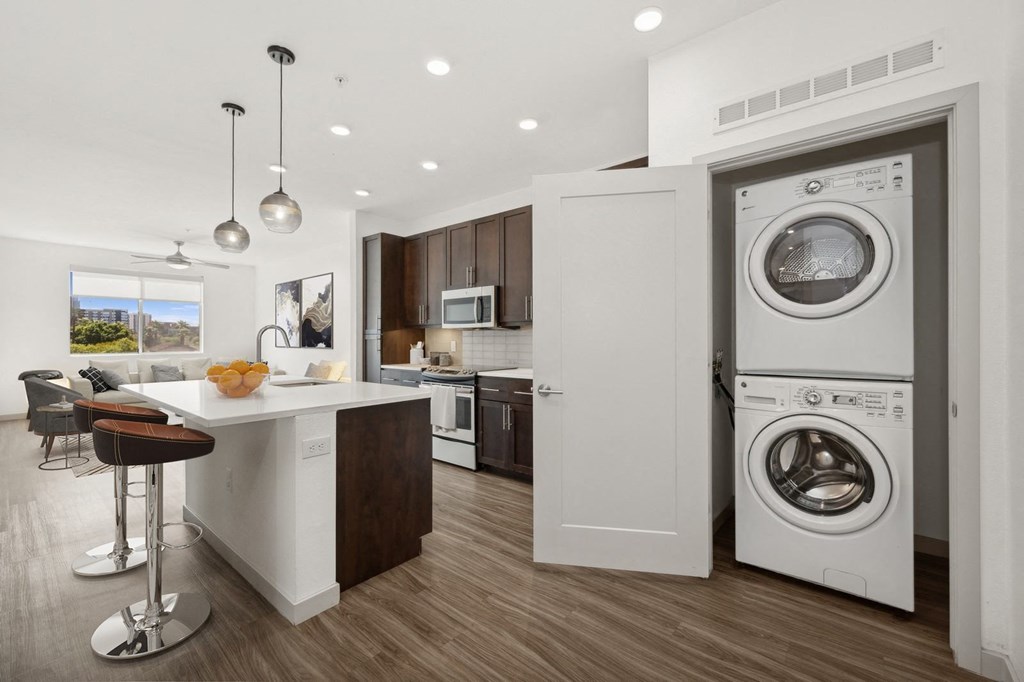 a kitchen with a washing machine and a washer and dryer