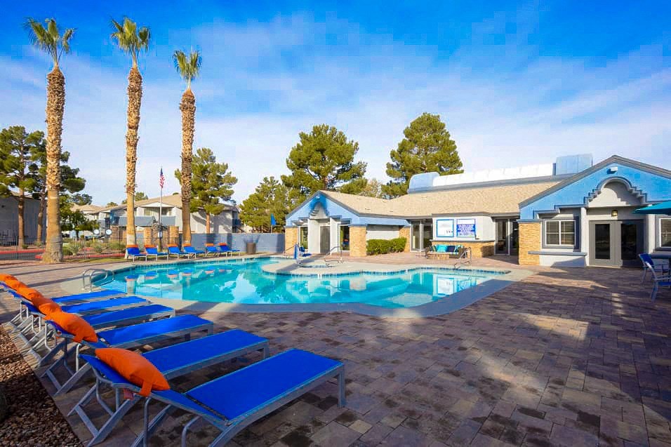 the pool at our apartments is full of lounge chairs and a resort style pool