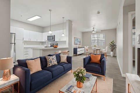 A living room with a blue couch and a coffee table.