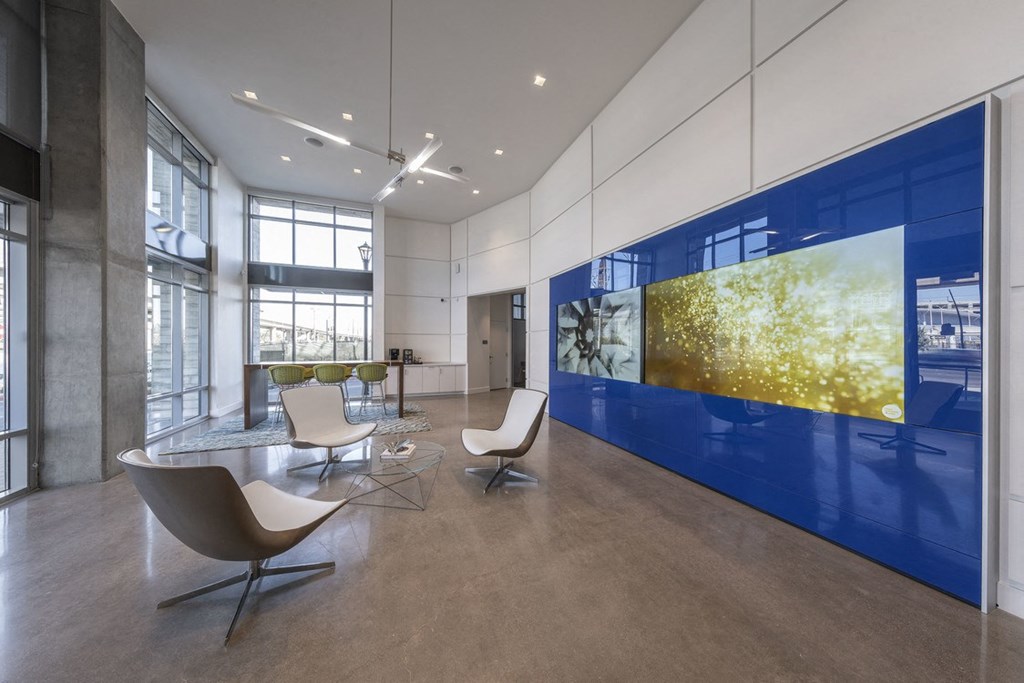 a room with a table and chairs and a large blue and yellow wall