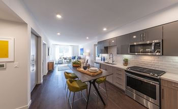 a kitchen with stainless steel appliances and a wooden table