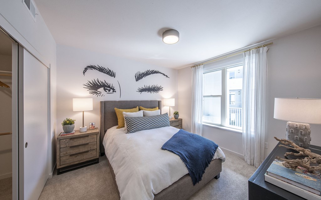 a bedroom with a large bed and a window