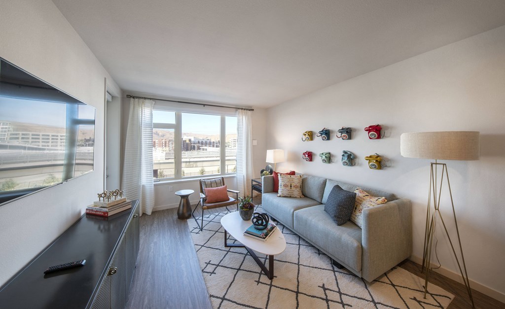 a living room with a couch and a table and a window