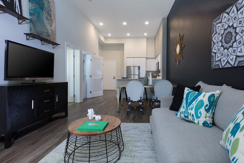 a living room with a couch and a table with chairs