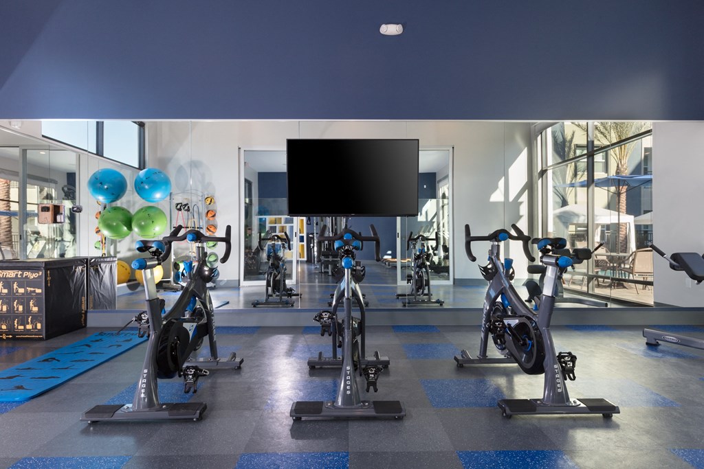 a spacious fitness center with treadmills and exercise bikes
