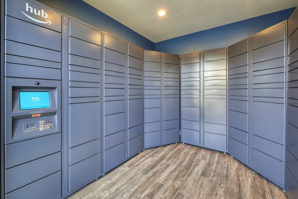 a bunch of blue lockers in a room with a coin machine