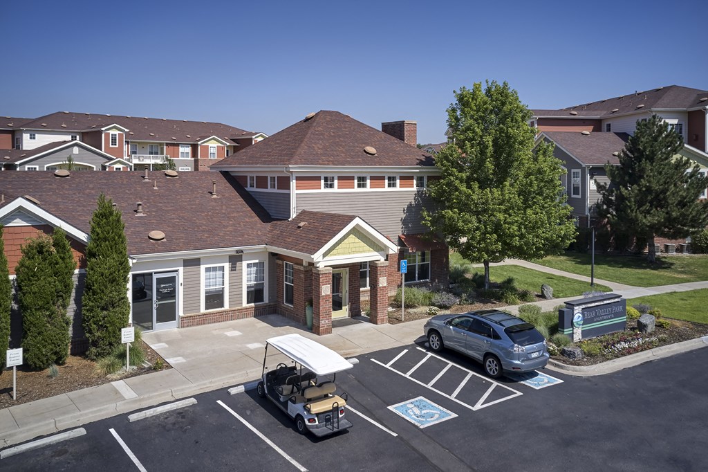 a house with a yard and a car parked in front of it