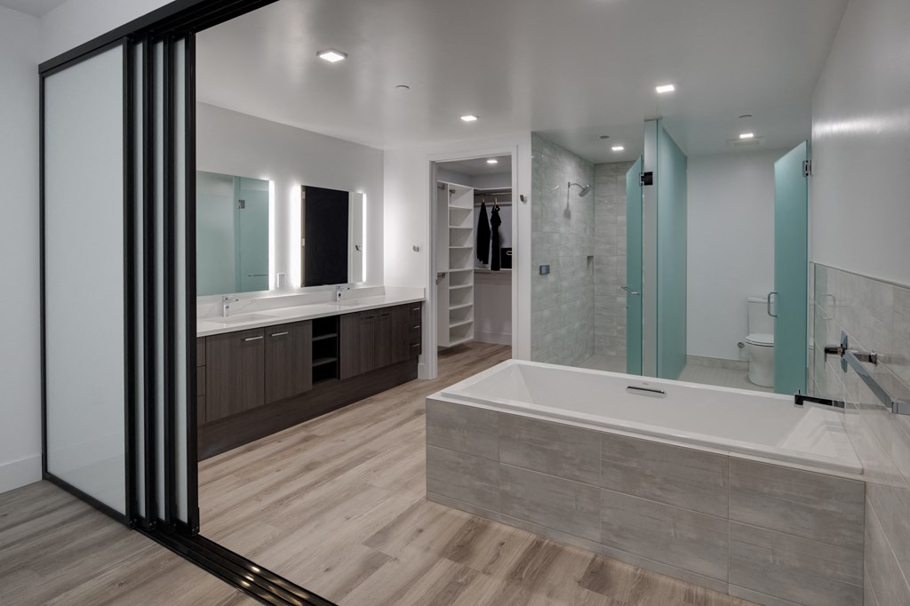 a large bathroom with a large tub and a shower and a sink