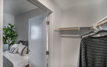a bedroom with a bed and a closet with a white door