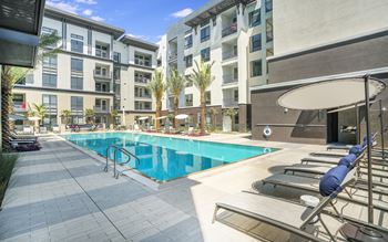 a swimming pool in front of an apartment building