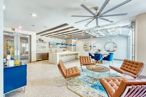 A living room with a blue sofa and a brown leather chair.