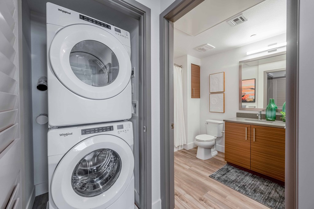 A white washing machine and dryer in a laundry room.