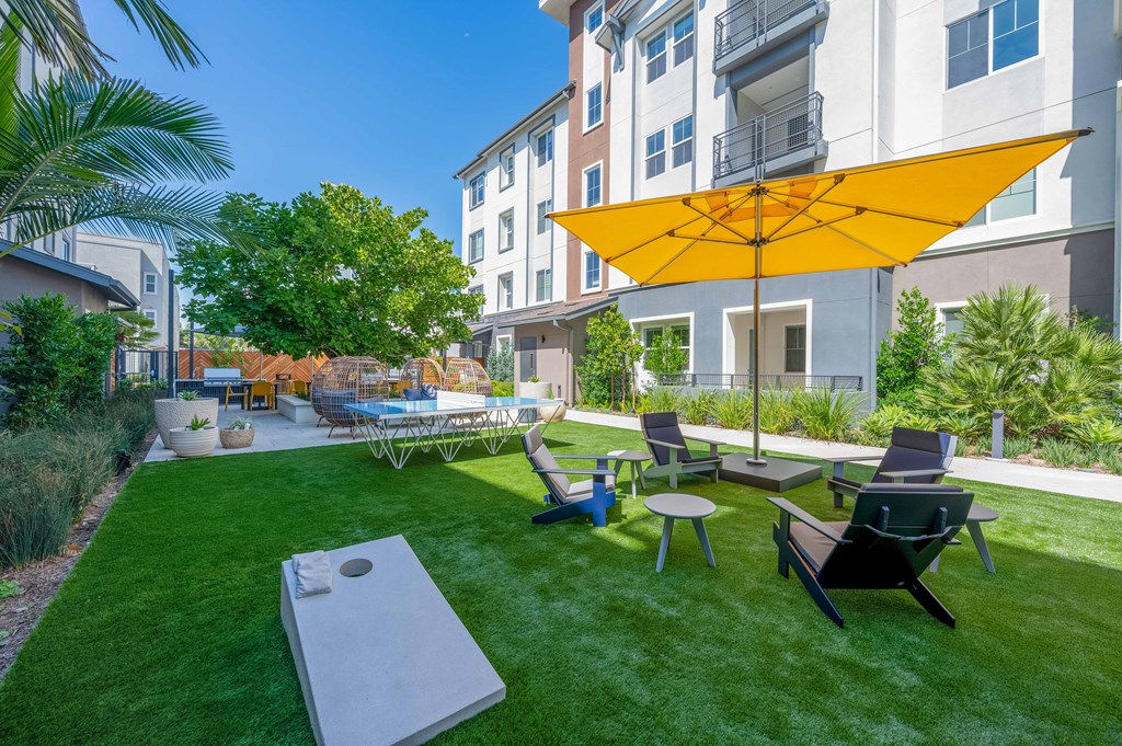 outdoor lounge area with cornhole