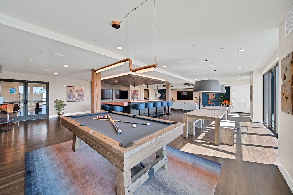 a game room with a pool table and a bar