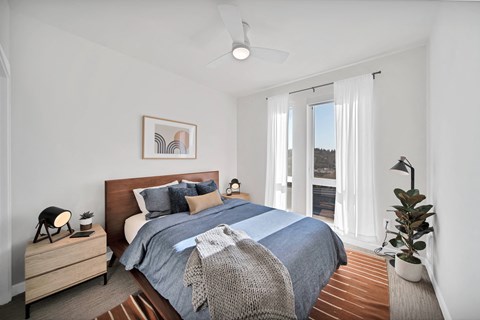a bedroom with a bed and a large window