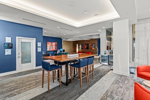 A dining area with a table surrounded by chairs.