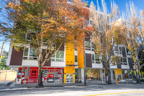 A building with a red fire hydrant in front of it.