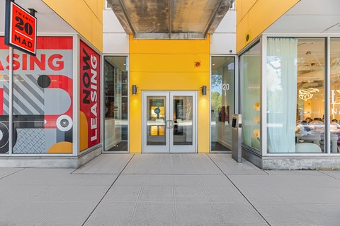 A yellow building with a sign that says "LEASING" on it.