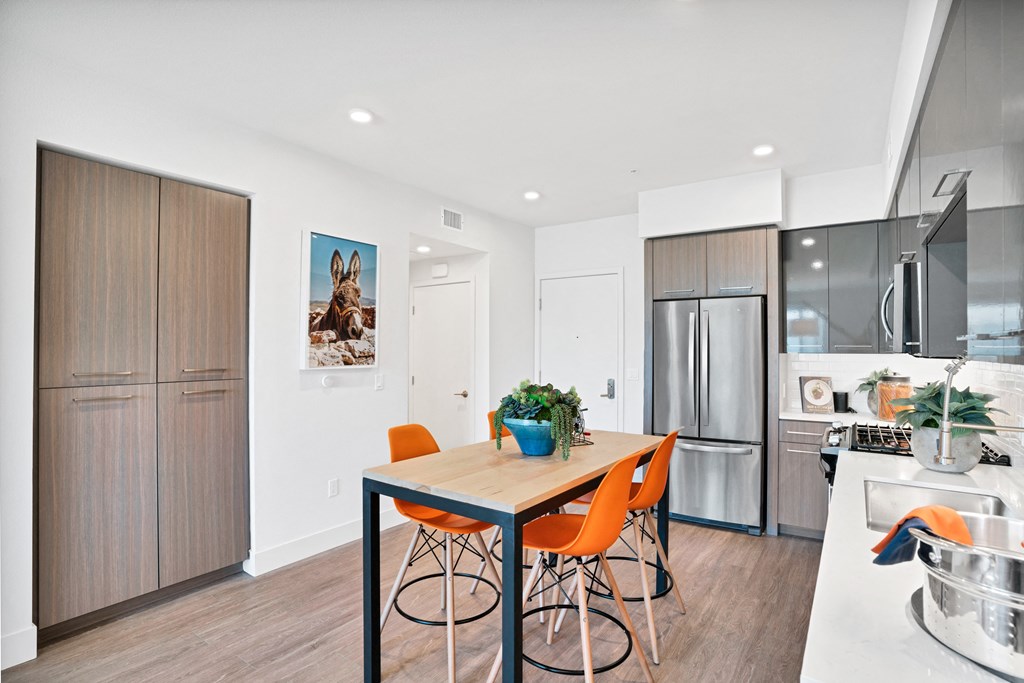 a kitchen and dining room with a table and chairs