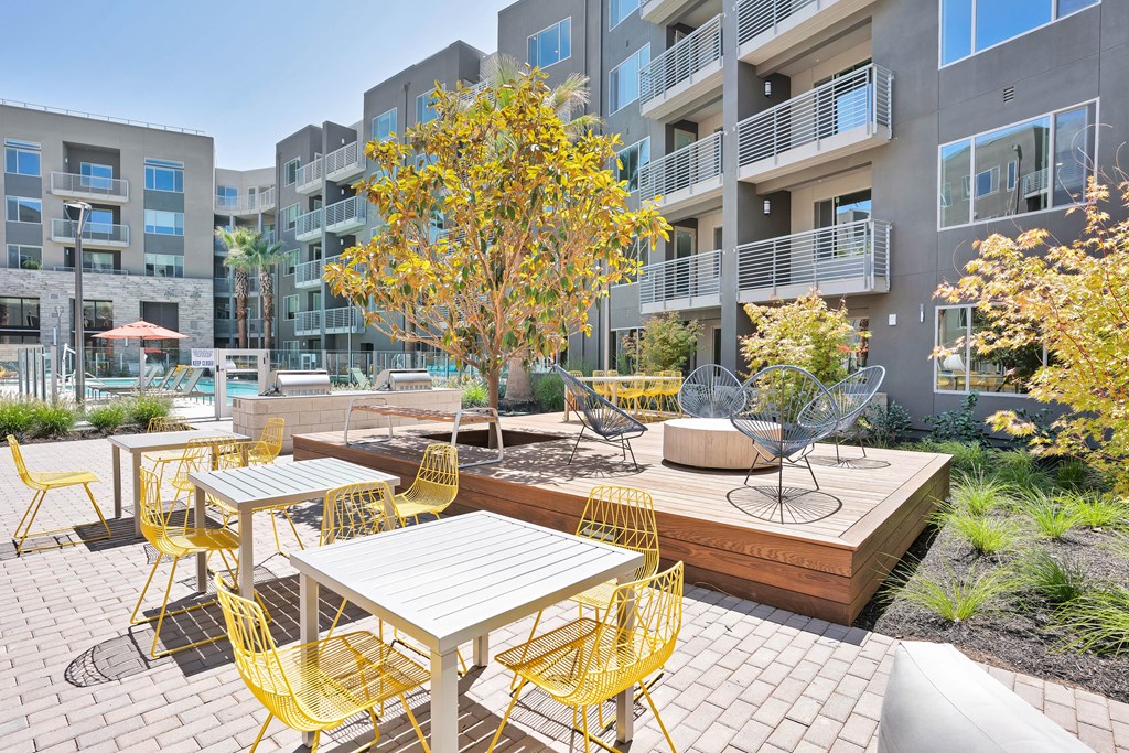 an outdoor patio with tables and chairs