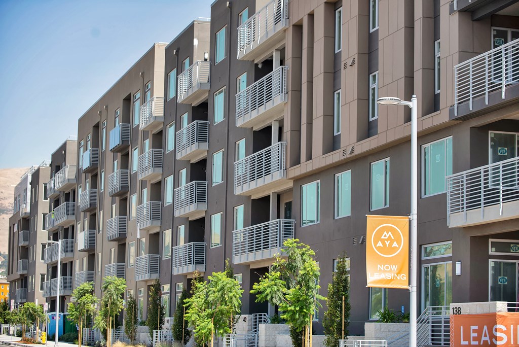 a building with balconies and trees in front of it