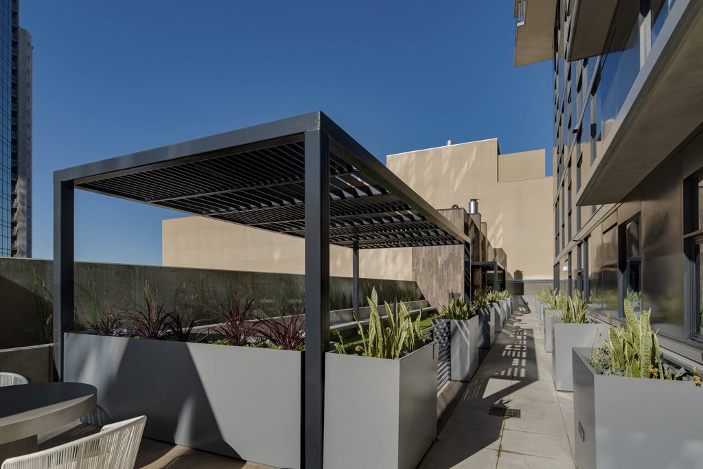 a pergola on a patio in front of a building