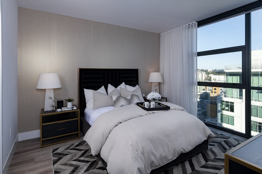 a bedroom with a large bed and a large window