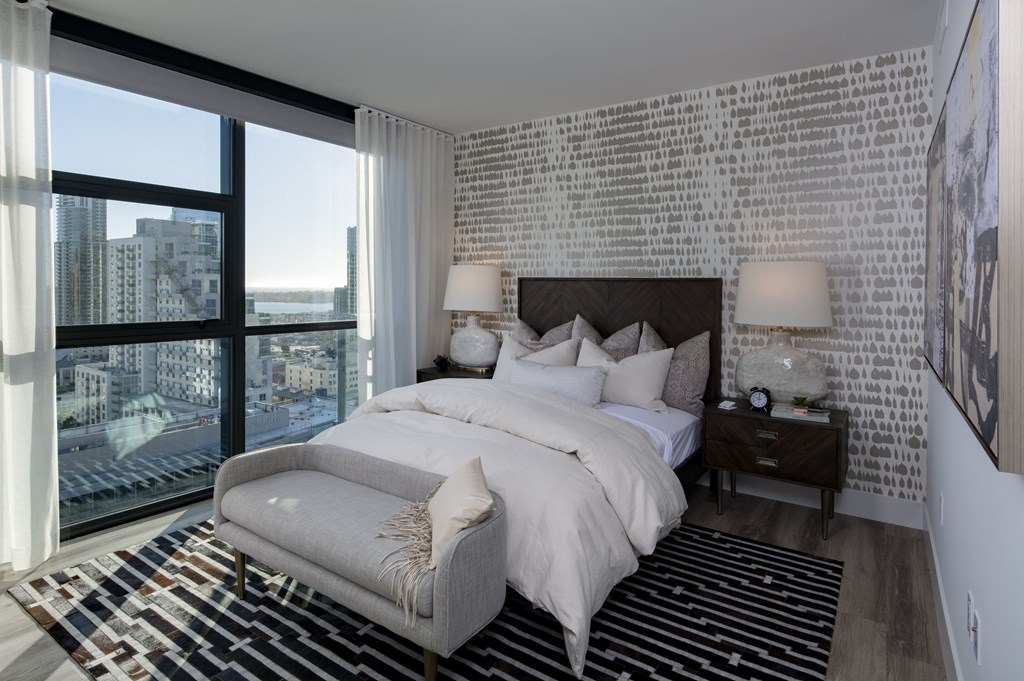 a bedroom with a large bed and a large window