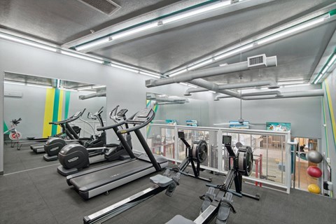 a gym with treadmills and other exercise equipment