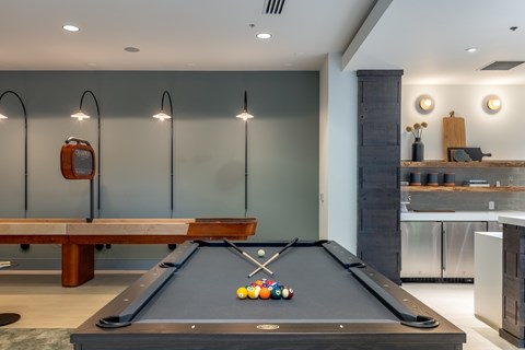 A pool table with a few balls on it in a room.